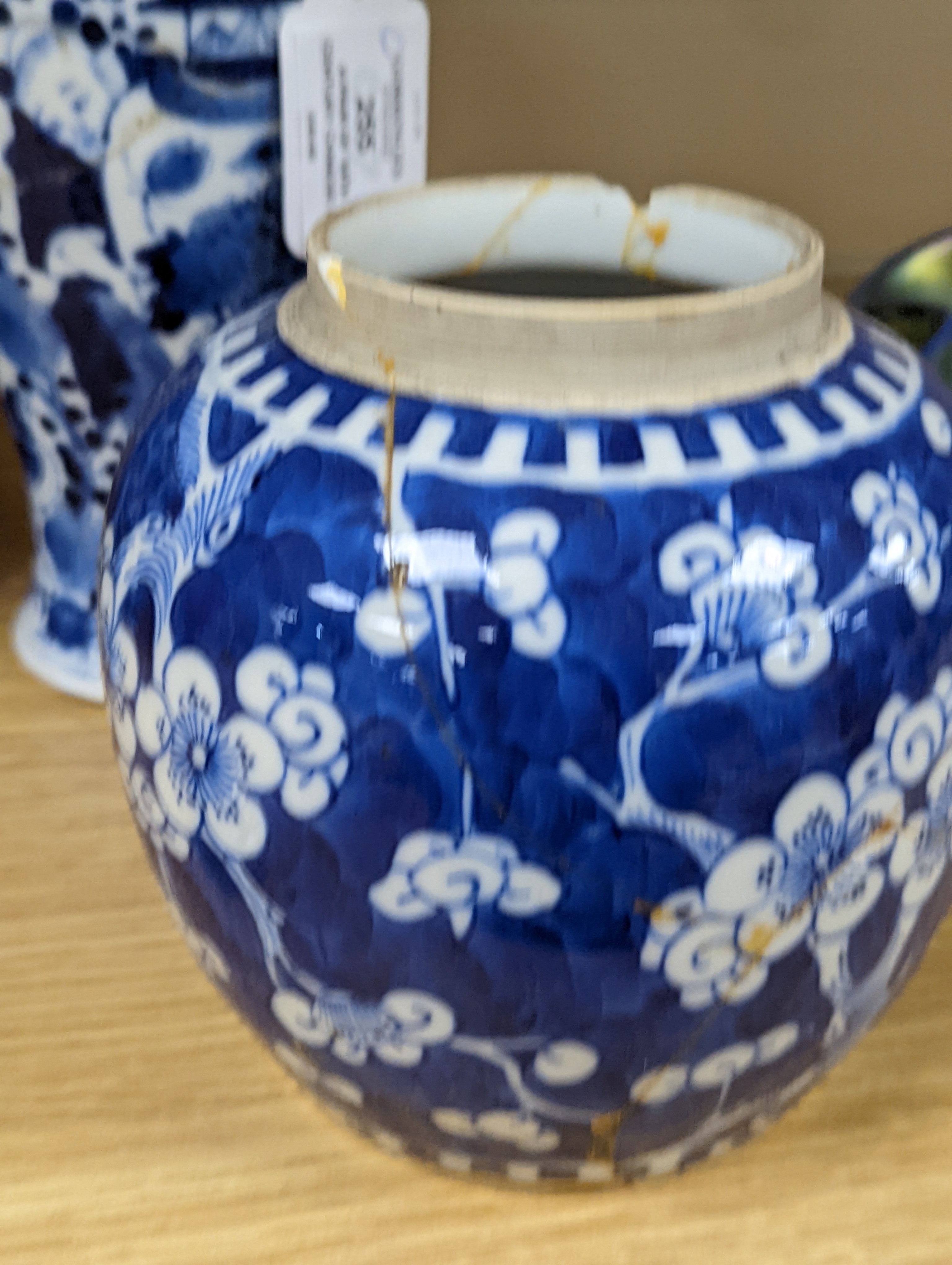 A pair of 19th century Chinese blue and white vases, a prunus vase and cover and a similar jar (4), pair of vases 24 cms high.
